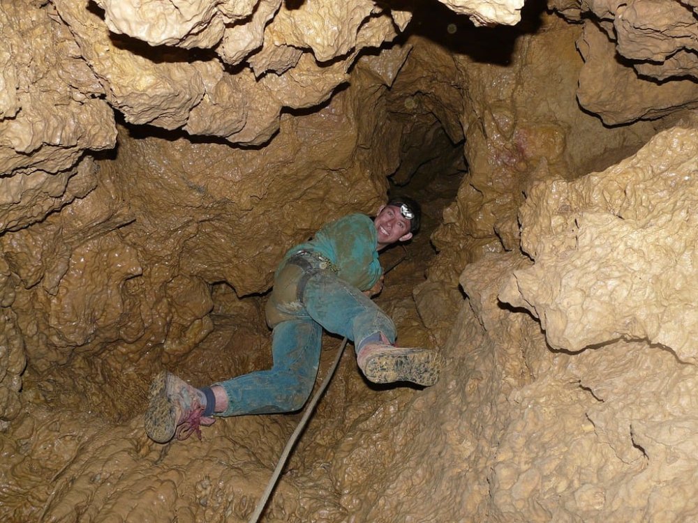 Man inside a Cave with a Rope