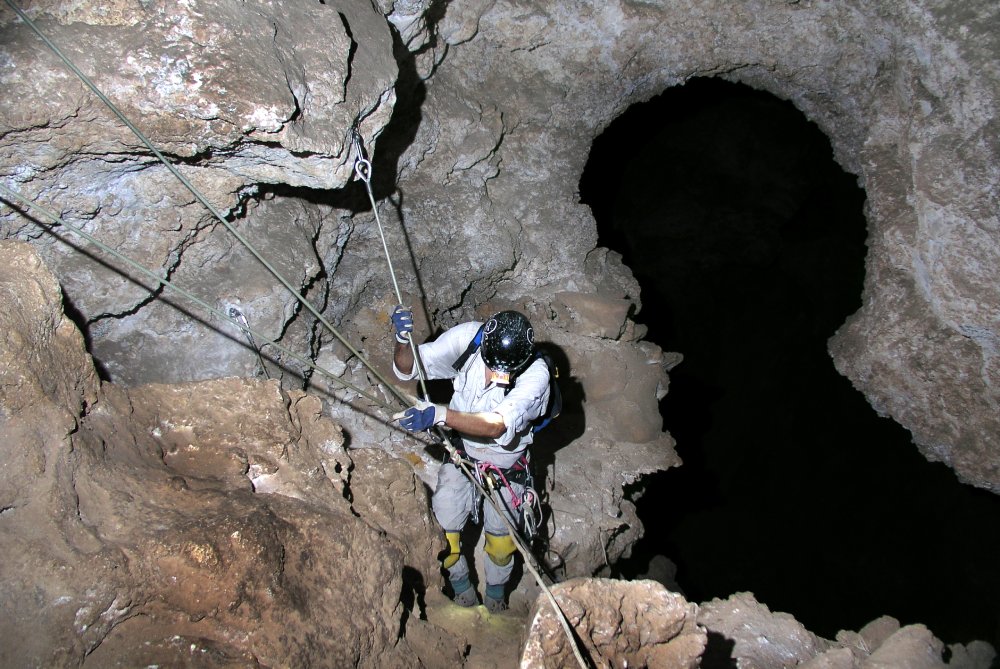 Man Climbing in a Cave