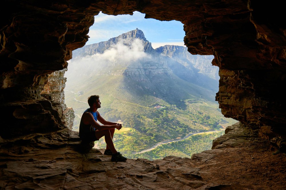 Man Sitting on a Cave